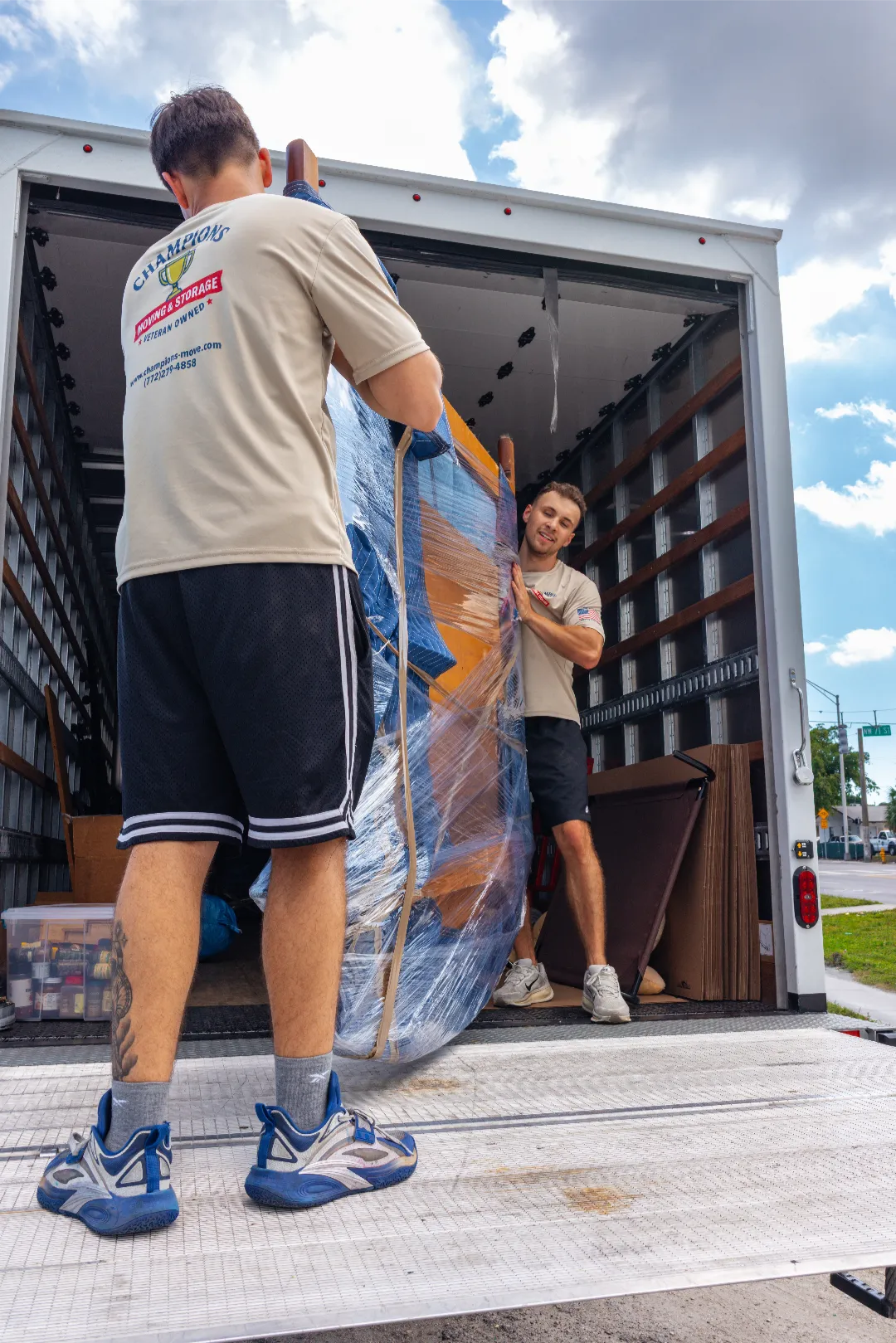 champions moving and storage florida loading furniture into truck
