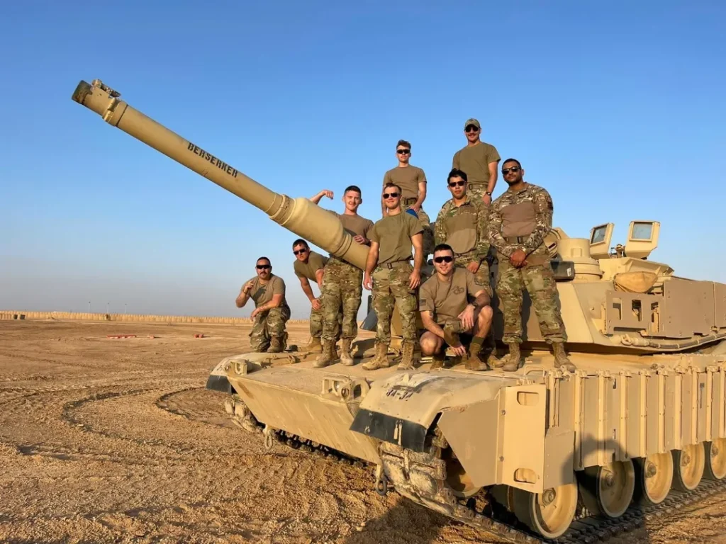 us army soldiers posing on m1 abrams tank berserker